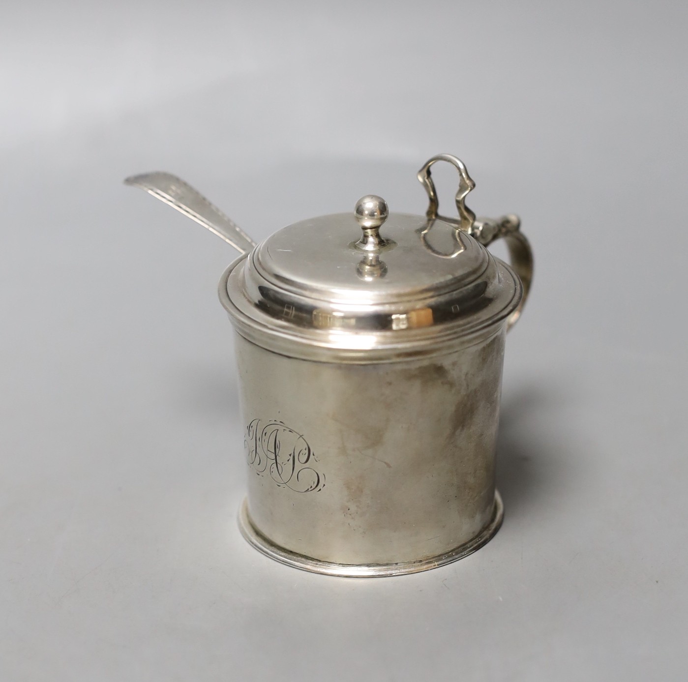 A George III silver drum mustard pot, London, 1772, height 71mm, with later associated silver spoon.